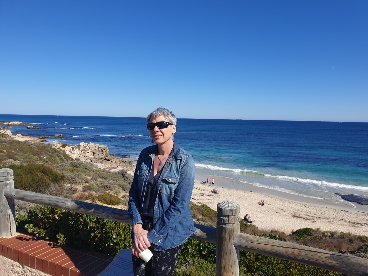 Woman standing by the ocean reflecting on survival mode, change and creating a new life in midlife Woman standing by the ocean reflecting on survival mode, change and creating a new life in midlife