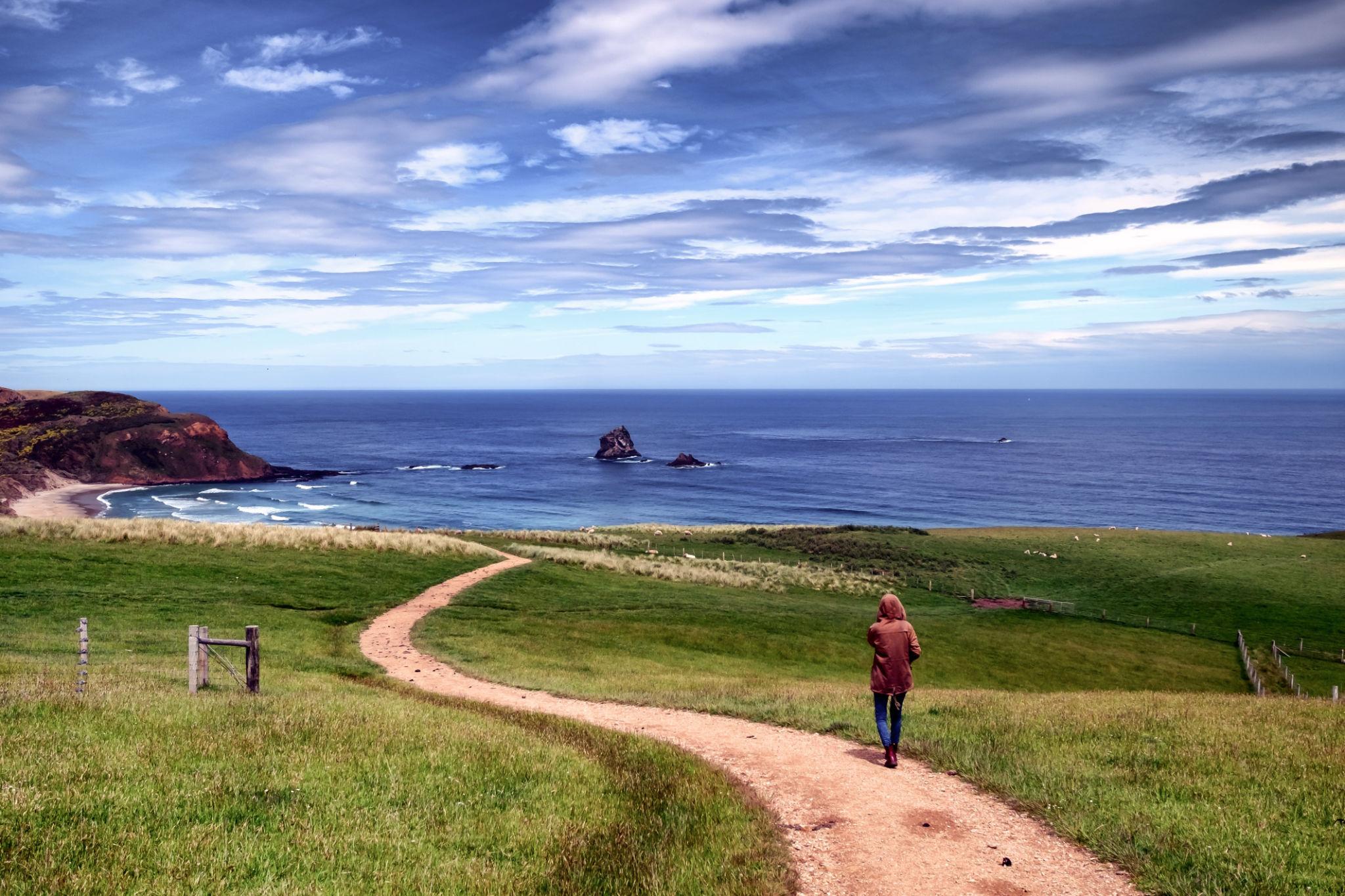 Woman Walking Towards Beach