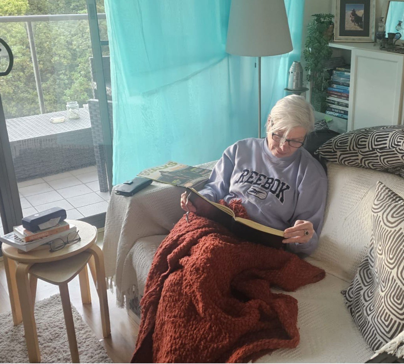 Woman sitting quietly and reflecting on the experience of not being fully back to herself yet in midlife. Woman sitting quietly and reflecting on the experience of not being fully back to herself yet in midlife.
