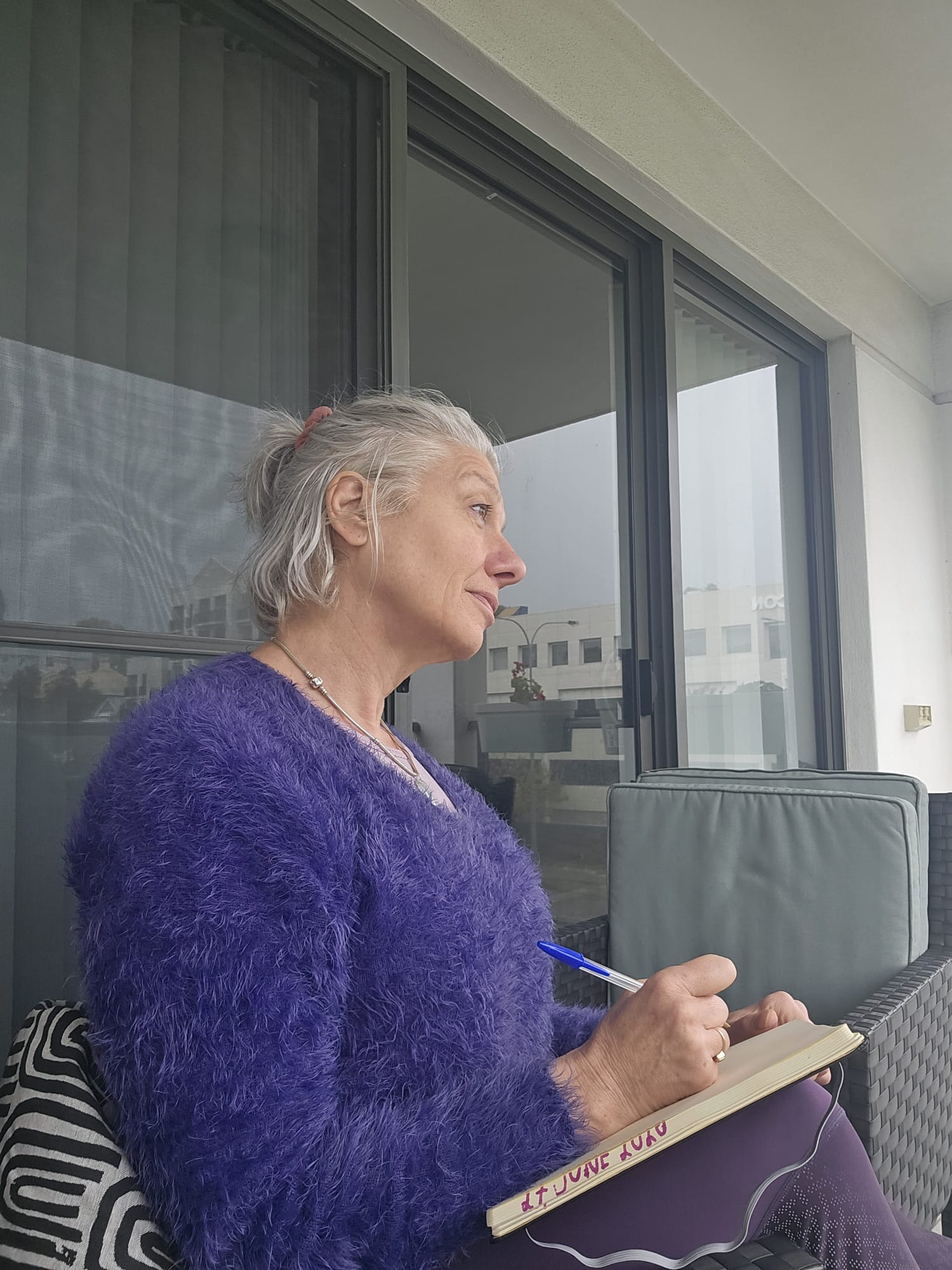 Woman looking into the distance reflecting on direction, effort and creating a life that fits in midlife.